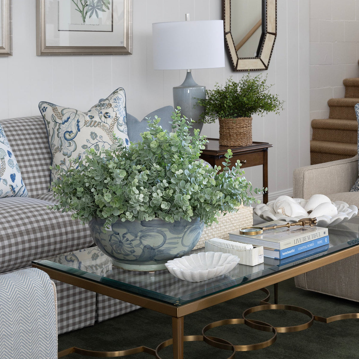 Eucalyptus Bush plants in a ceramic bowl on a glass coffee table.