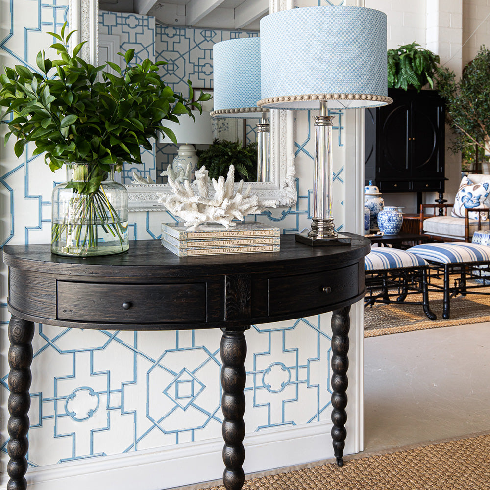 Image of Martha Console in entryway. Styled with greenery, books, coral and a lamp