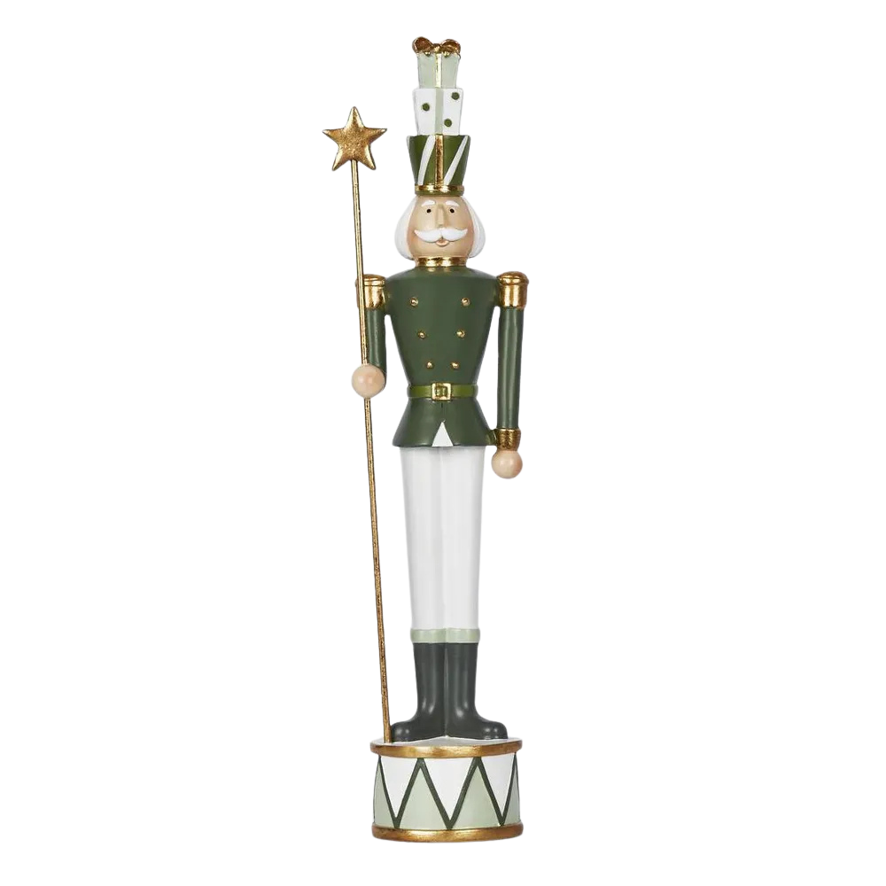 Decorative nutcracker figure holding a star on a white background