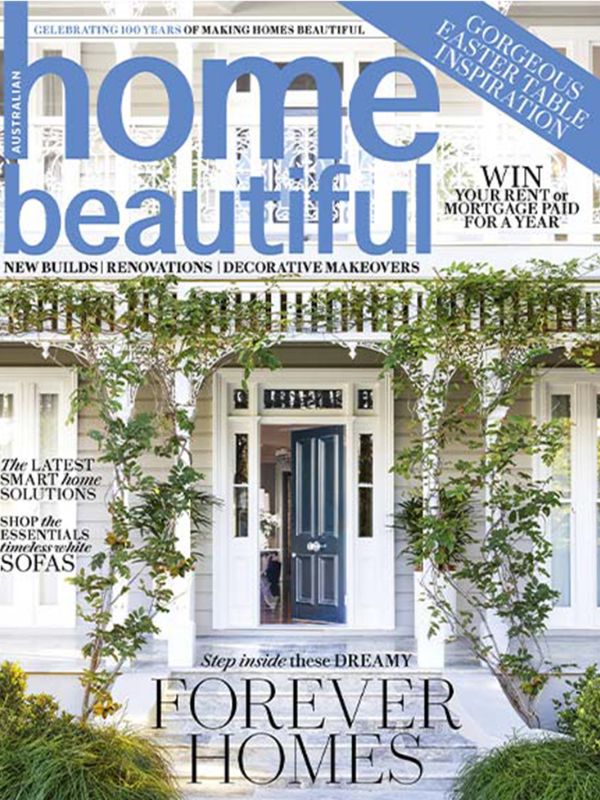 Front cover of Home Beautiful magazine featuring a white house facade with a blue front door, green vines climbing the porch, and large blue and black title text across the top.