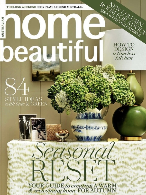 Front cover of Home Beautiful magazine featuring a styled interior scene with a large green floral arrangement in a blue-and-white vase, green ceramic vessels, and large cover text reading 'home beautiful' and 'Seasonal RESET'.