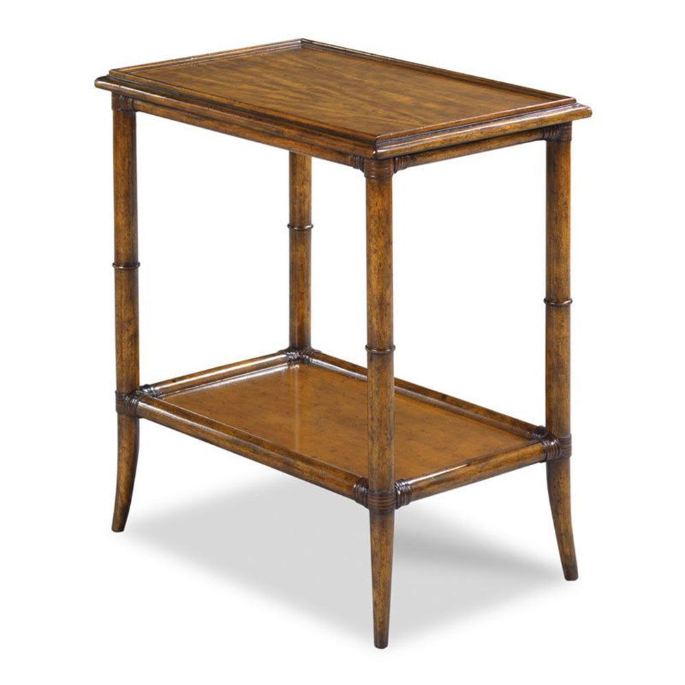 A rectangular wooden side table with bamboo-style legs and a lower shelf, veneered in rich prima vera with leather-bound joinery.